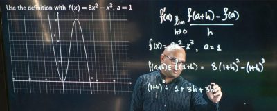 UConn Edtech Lightboard being used for a mathematical equation.